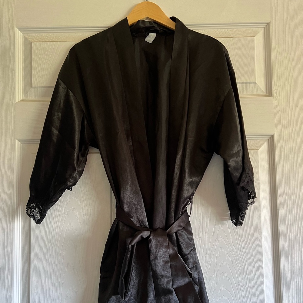 Fredrick’s of Hollywood black satin short robe with waist sash. Size small.